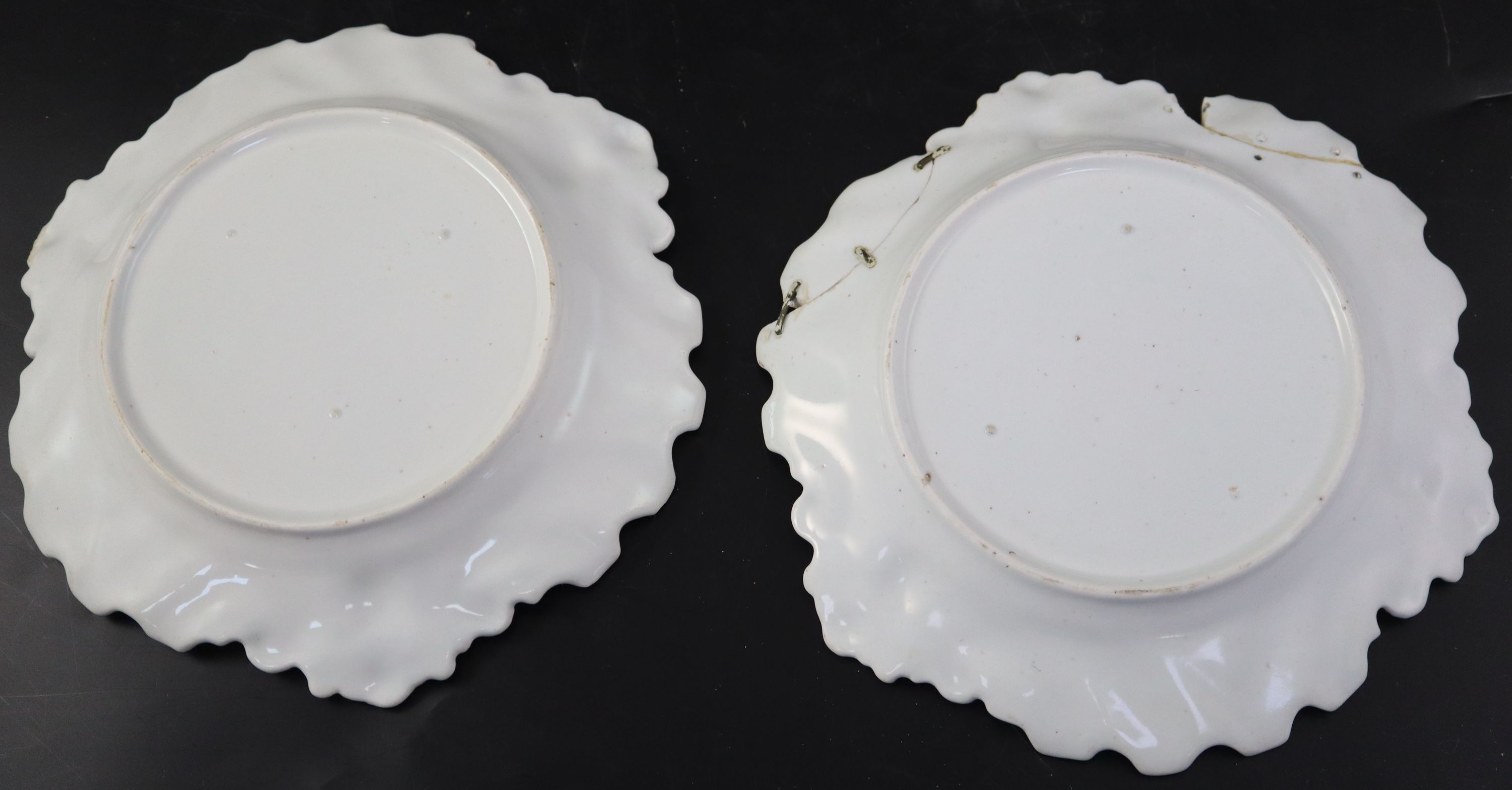 A pair of Chelsea Red Anchor period silver shaped plates, c.1752, diameter 23cm (a.f.)